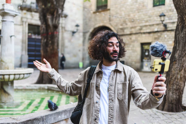 istock Man recording vlog on street 1364451260