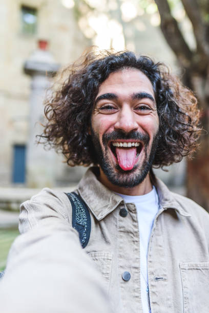 istock Cheerful man taking selfie on street 1364451261