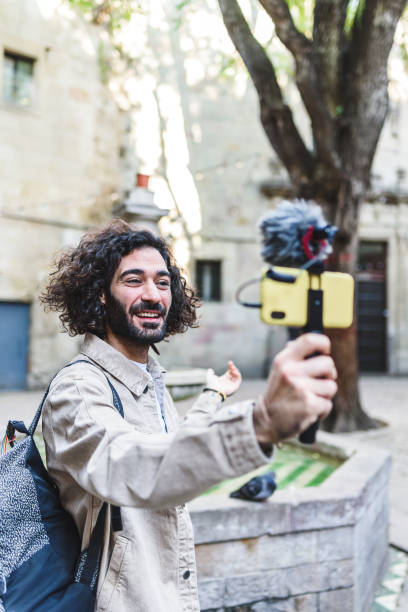 istock Smiling blogger recording video on street 1364451263
