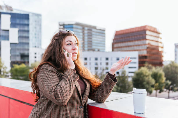 istock Woman speaking on cellphone near takeaway coffee 1364451819