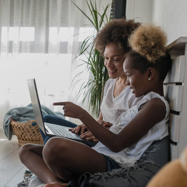 istock Mother and daughter looking something on a laptop computer at home. Bonding 1364452097