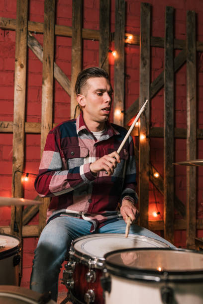 istock Male musician playing drums on stage 1364453316