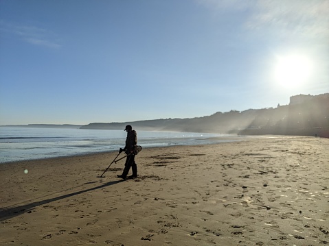 A lone fisherman on the seashore