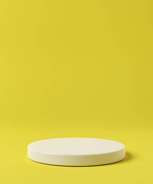 istock Simple white podium on yellow background. Product presentation mock up. 1364456301