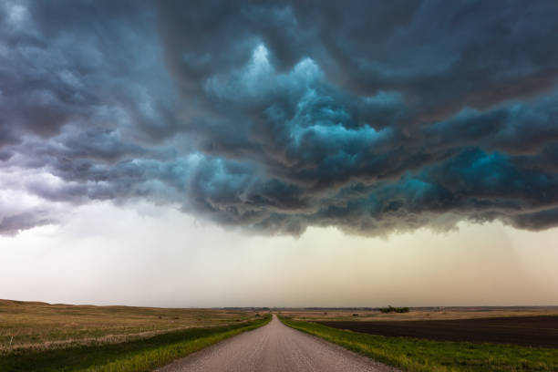 istock Ominous storm clouds over a dirt road 1364460079