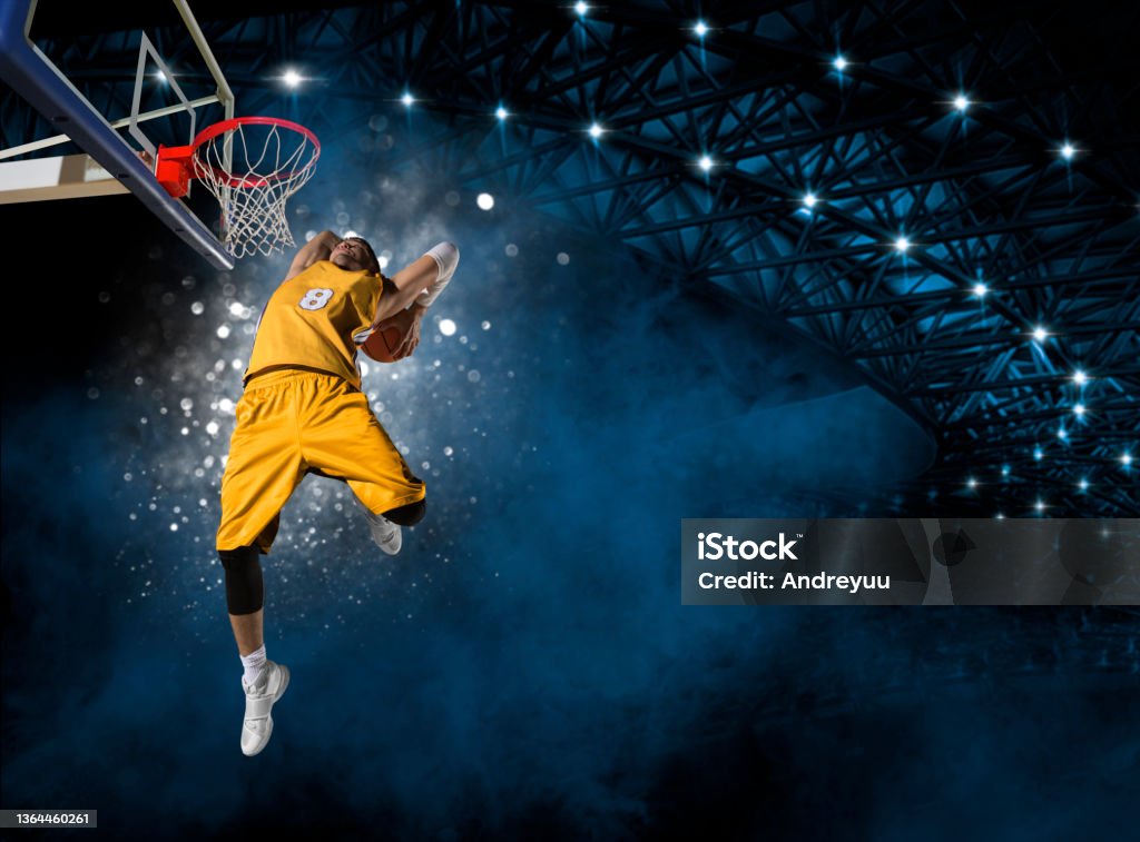 Basketball player players in action Basketball player players in action. Basketball concept on dark smoke background Basketball - Sport Stock Photo