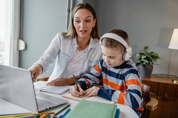 istock Mother helps her son with his homework 1364463561