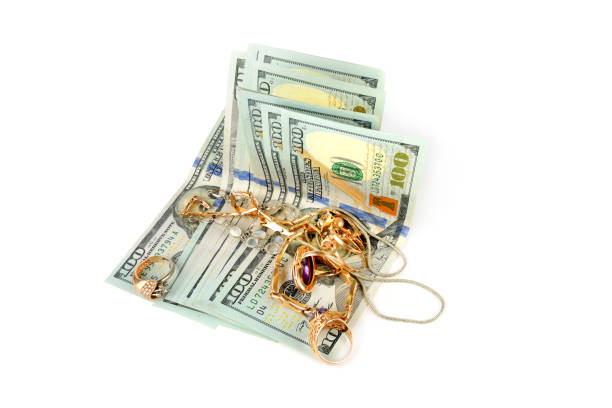 istock US dollars and jewelry isolated on white background. 1364464727