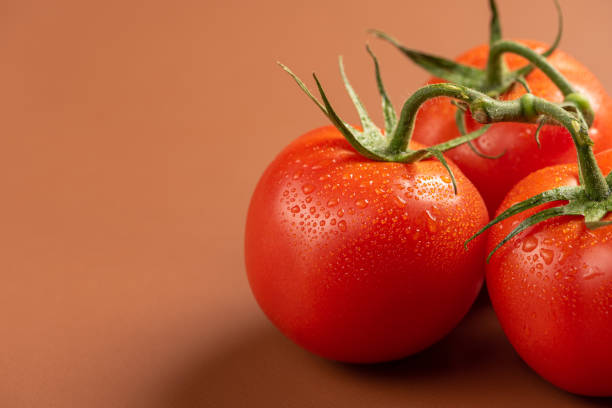 istock Tomatoes, beautiful tomatoes in details arranged on a brown leather, selective focus. 1364466016
