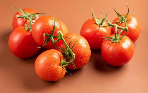 istock Tomatoes, beautiful tomatoes in details arranged on a brown leather, selective focus. 1364466018