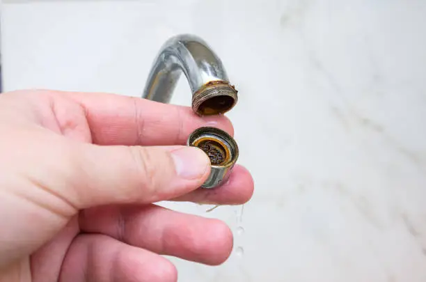 Photo of Dirty and clogged aerator from kitchen sink faucet.