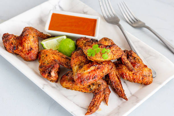istock Baked Chicken Wings with Condiment and Lemon, Fresh Cilantro 1364466406