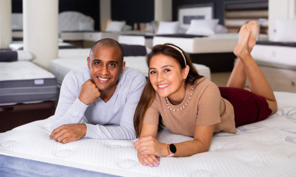 istock Cheerful young married couple lying on mattress 1364470489