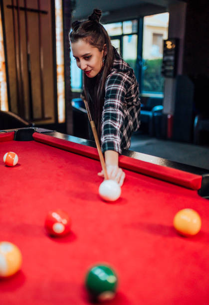 istock Woman playing pool in the bar 1364471508