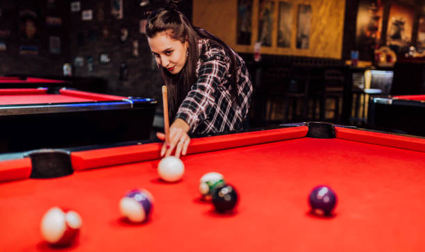 istock Woman playing pool in the bar 1364471743