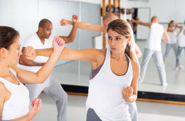 istock Young woman practicing self defence techniques with female partner 1364472450