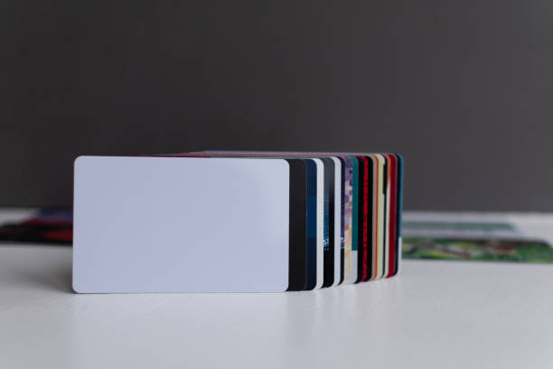 istock Blank white plastic card close-up in foreground 1364472583