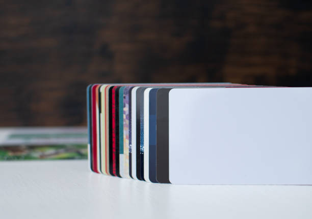 istock Blank white plastic card close-up in foreground 1364472586
