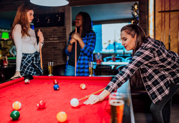 istock Female friends playing pool 1364472685