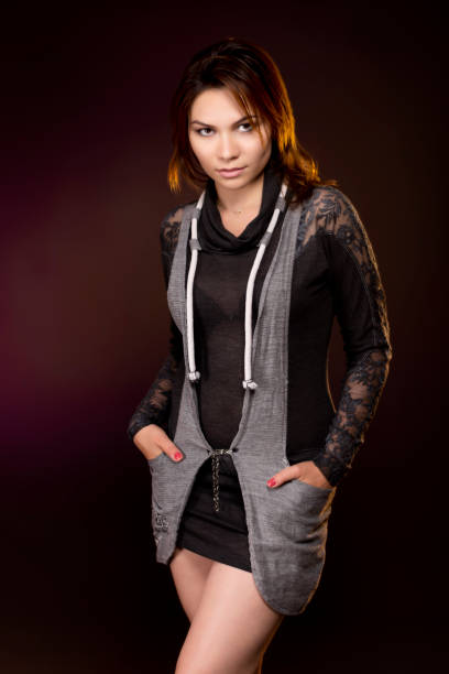 istock Redhead young woman posing looking at camera in dark studio. 1364474001