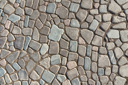 The texture of natural stone paving.