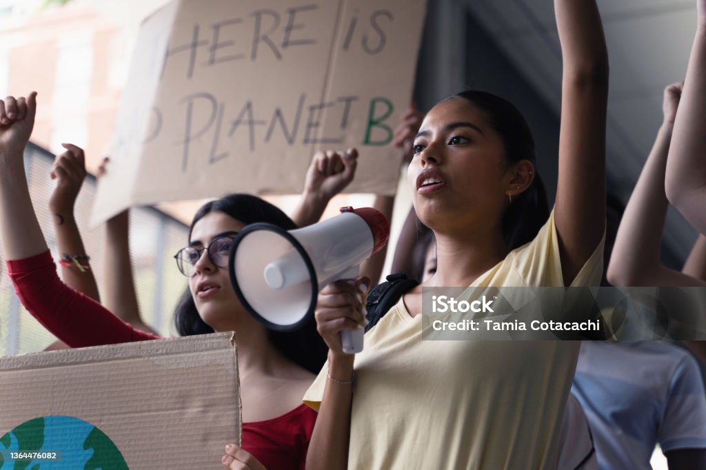 Female hispanic latin teenager students with placards and posters on global protest for climate change and Earth rights Protest Stock Photo
