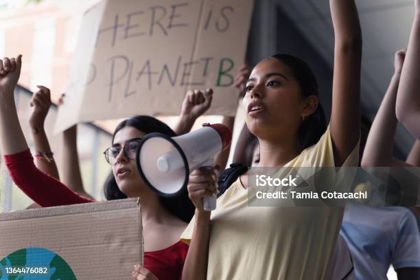 Female Hispanic Latin Teenager Students With Placards And Posters On Global Protest For Climate Change And Earth Rights Stock Photo - Download Image Now