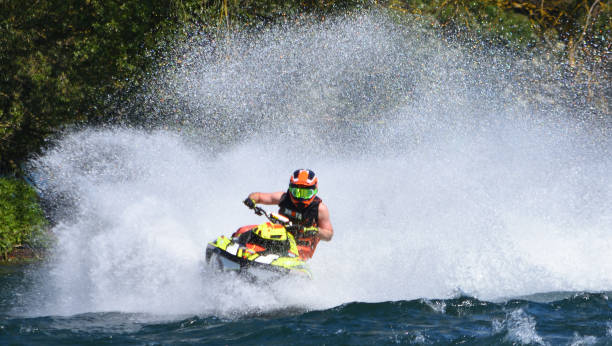 jet ski  race competitor cornering at speed creating at lot of spray. - wake jet boat water water sport imagens e fotografias de stock