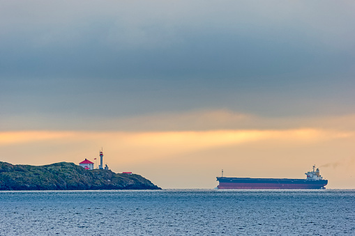 Trial Islands Lighthouse and Freighter off the west coast of Victoria on Vancouver Island, British Columbia