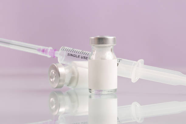 istock Vaccine bottle with blank white label.Vaccination, immunization, treatment to provides active acquired immunity to a particular infectious disease. Healthcare And Medical concept. 1364479988