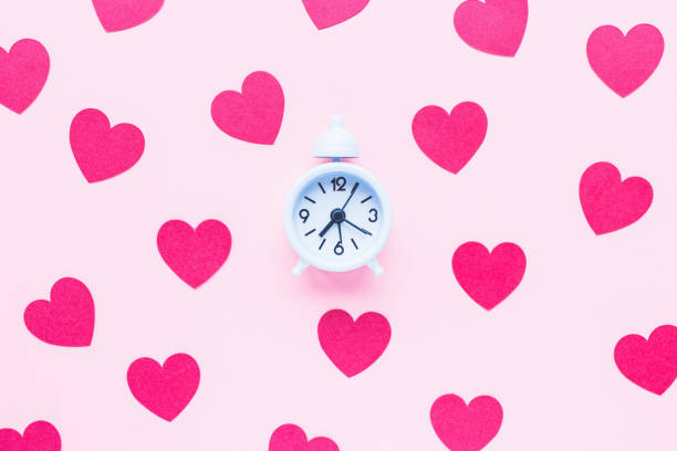 istock Valentines Day background with alarm clock and hearts 1364483845