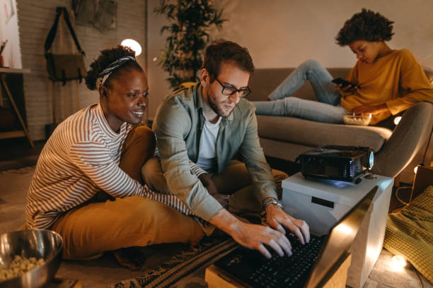 istock Man with family starting projector with laptop 1364485739