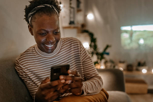 istock Smiling young woman using smart phone 1364486233