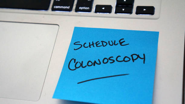 Reminder to Schedule Colonoscopy Sticky note reminder to schedule colonoscopy to screen for colorectal cancer. colorectal cancer photos stock pictures, royalty-free photos & images