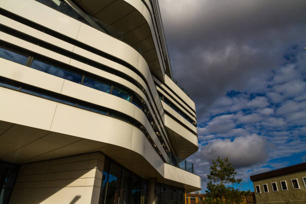 istock Modern building with clear lines against blue sky and clouds, landscape, copyspace. 1364490092