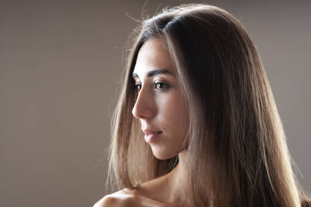 istock Beautiful brunette girl studio portrait. Serious face expression. 1364490294