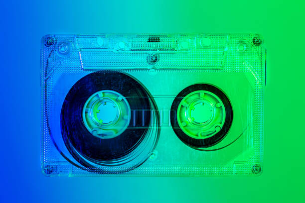 istock Plastic transparent cassette tape - blue and green background, pop art style 1364492360