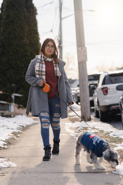 istock Latin girl walking with the dog 1364493208