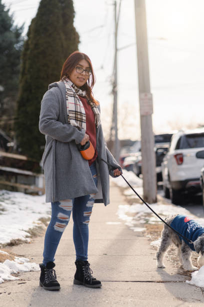 istock Latin girl walking with the dog 1364493260