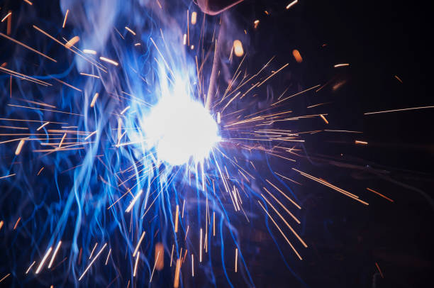 istock Worker industrial welding do elements of iron construction. Process by manual welding. Splatter 1364494418