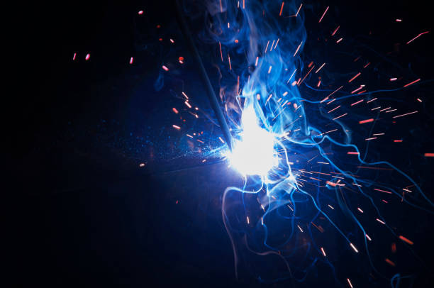 istock Worker industrial welding do elements of iron construction. Process by manual welding. Splatter 1364494470