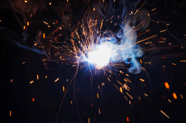 istock Worker industrial welding do elements of iron construction. Process by manual welding. Splatter 1364494475