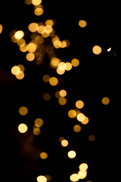istock Defocus lights, garlands on the Christmas tree. Lights on a black background 1364498961