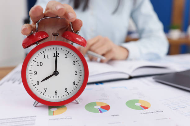 istock Woman turn off timer on clock at eight oclock in morning, time start work 1364501610