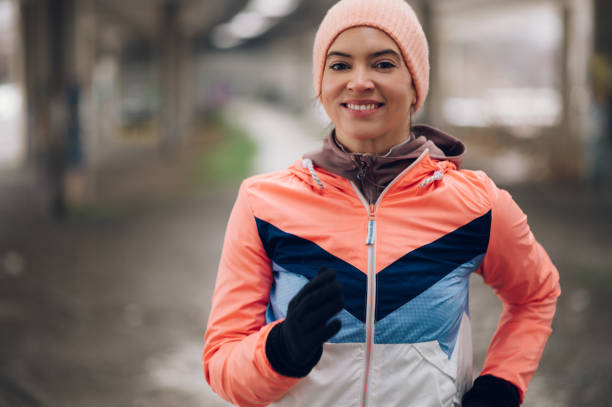 istock Woman running under the bridge on a cold winter day. 1364501717