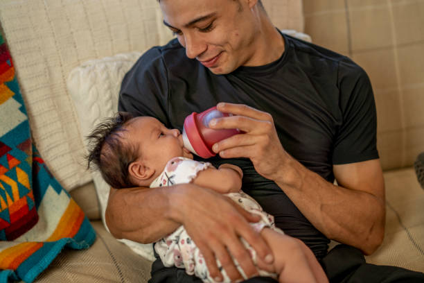 istock Young man caring for baby 1364504801