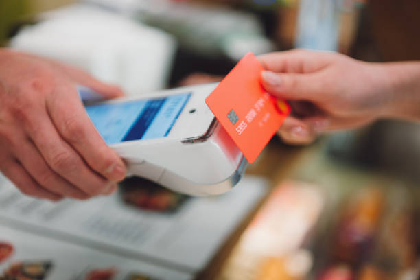 asian beautiful woman paying a bill using contactless payment by smartphone. - credit card reader imagens e fotografias de stock