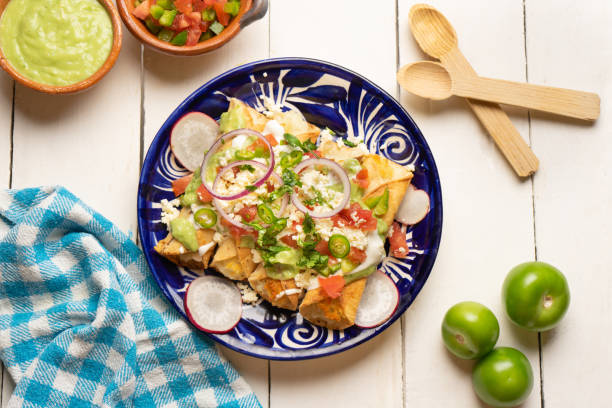 istock Mexican fried potato tacos called flautas with guacamole and cheese 1364504880