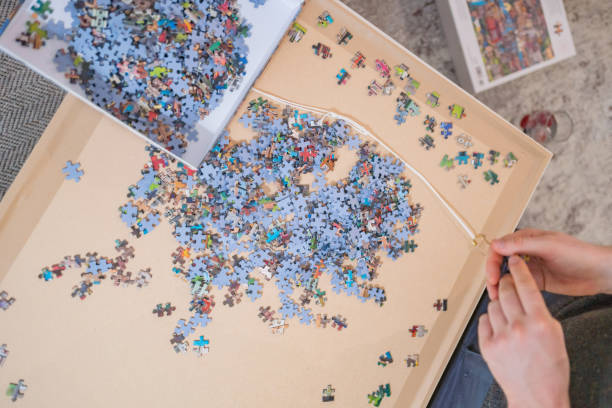 istock Young man builds puzzle in living room 1364512325