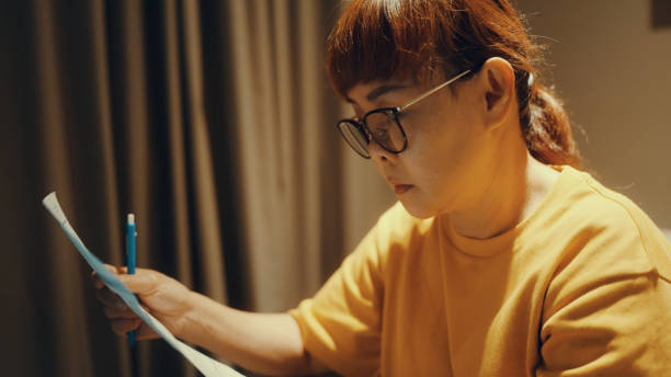 istock Asian women calculate personal budget 1364513353